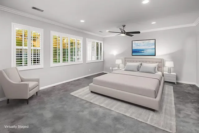 a bedroom with a bed a couch and a window