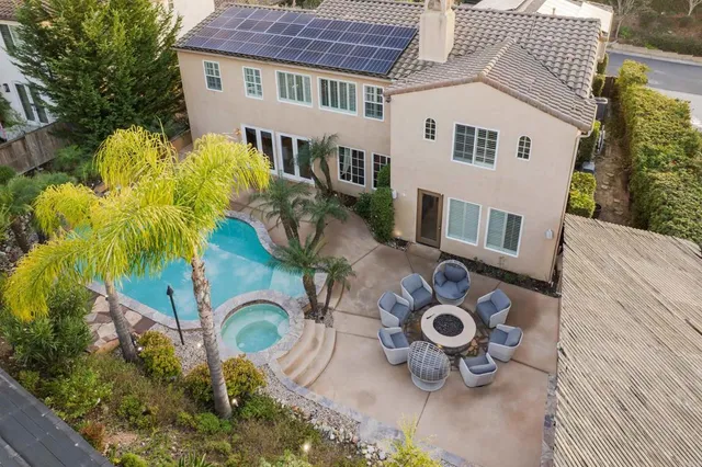 a backyard of a house with barbeque oven fire pit and outdoor seating
