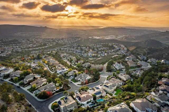 an aerial view of residential houses with city view