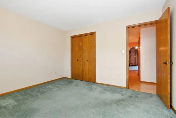 an empty room with closet area