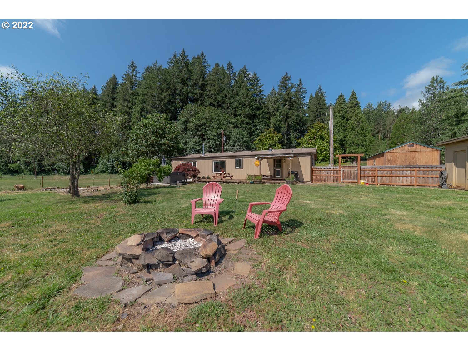 90611 Hill Road Springfield, OR 97478 - Photo 5 of 32 a view of a house with backyard sitting area and garden