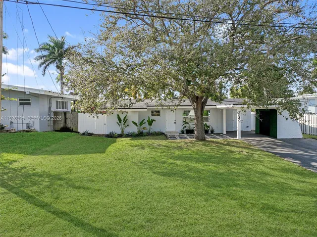 an aerial view of a house with swimming pool having outdoor seating