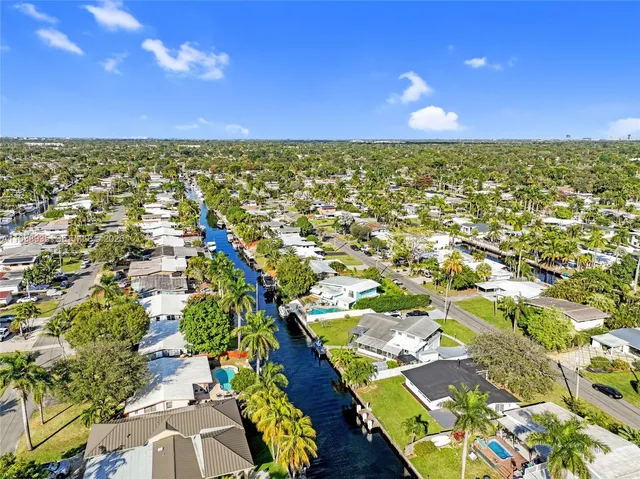an aerial view of residential houses with outdoor space and swimming pool