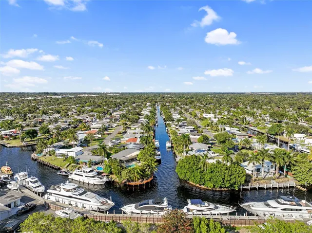 an aerial view of residential houses with outdoor space and swimming pool