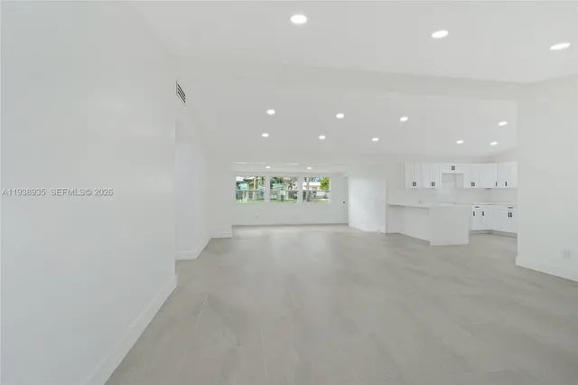 a view of a kitchen with white cabinets