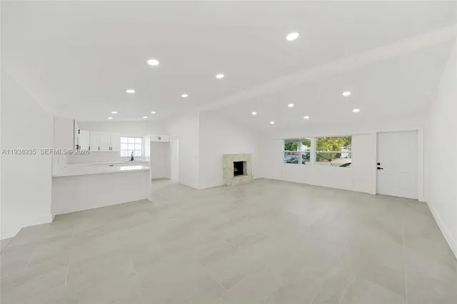 a view of a kitchen with white cabinets