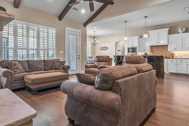 a living room with furniture and a ceiling fan