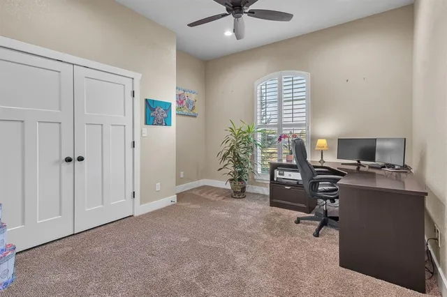 a bedroom with a bed and a ceiling fan