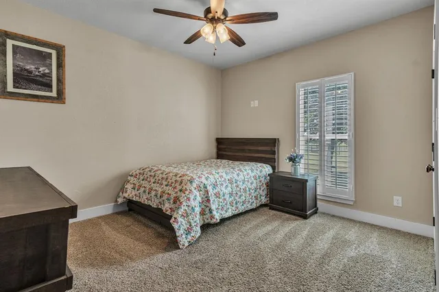 a bathroom with a granite countertop sink a toilet and a mirror