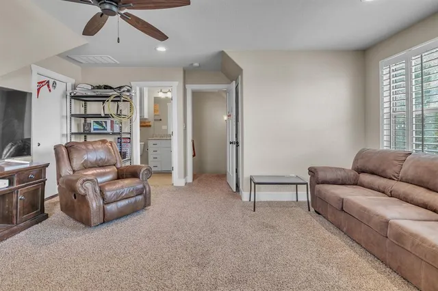 a bathroom with a granite countertop sink and a toilet