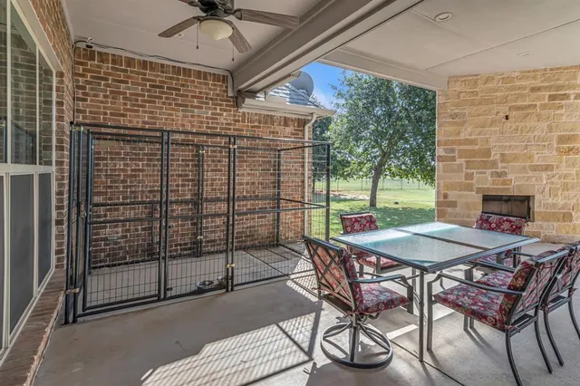 a view of a patio with a table and chairs