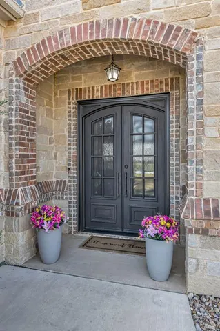 a living room with furniture a couch and potted plants