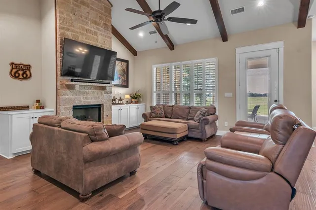 a living room with furniture fireplace and flat screen tv