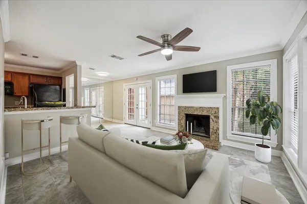 a living room with furniture a fireplace and a flat screen tv