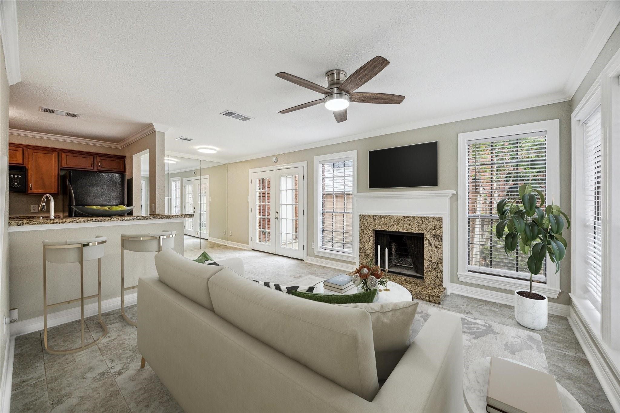a living room with furniture a fireplace and a flat screen tv