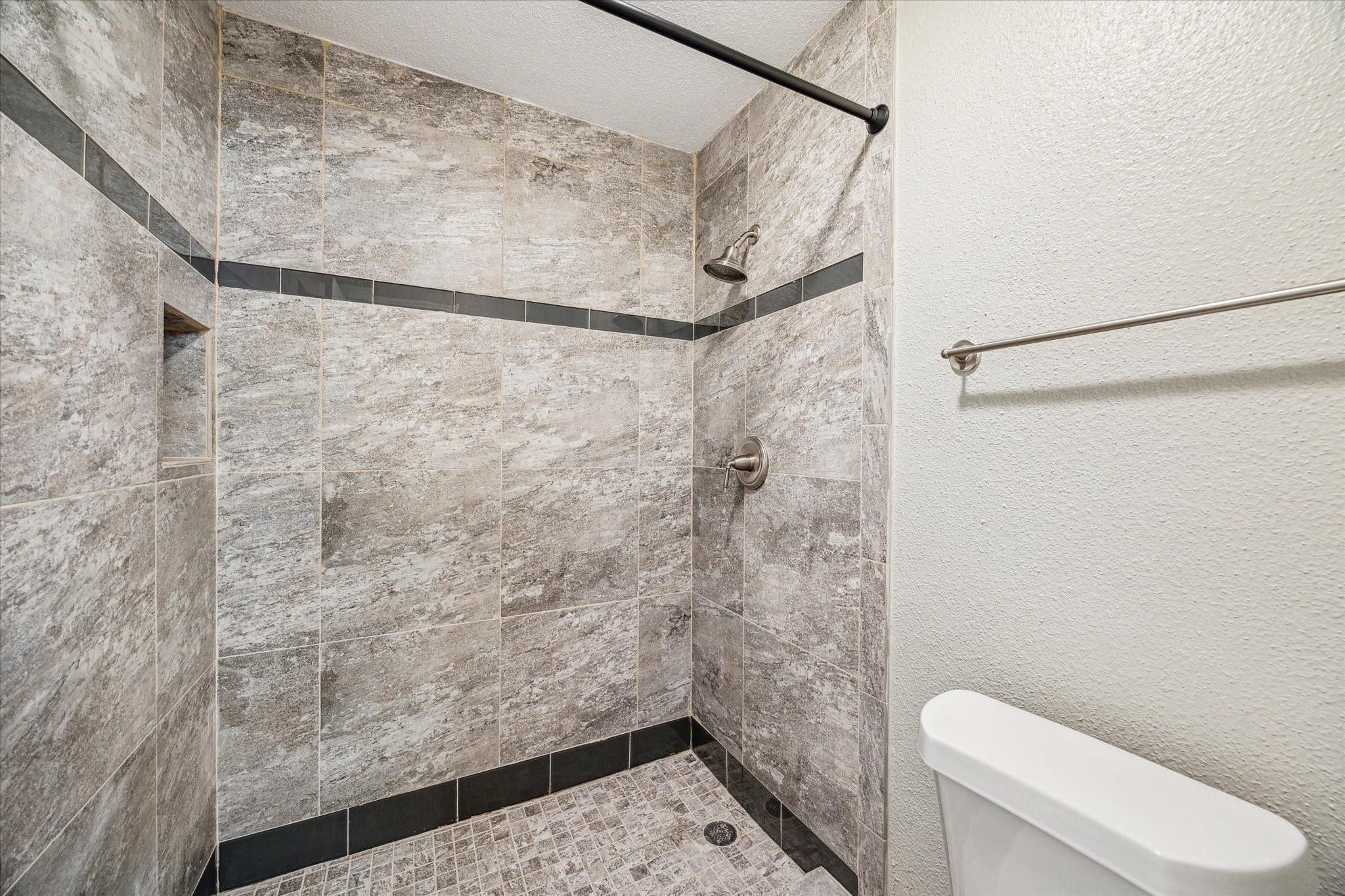 2211 South Kirkwood Road, Unit 9 Houston, TX 77077 - Photo 14 of 16 a bathroom with a toilet and a shower