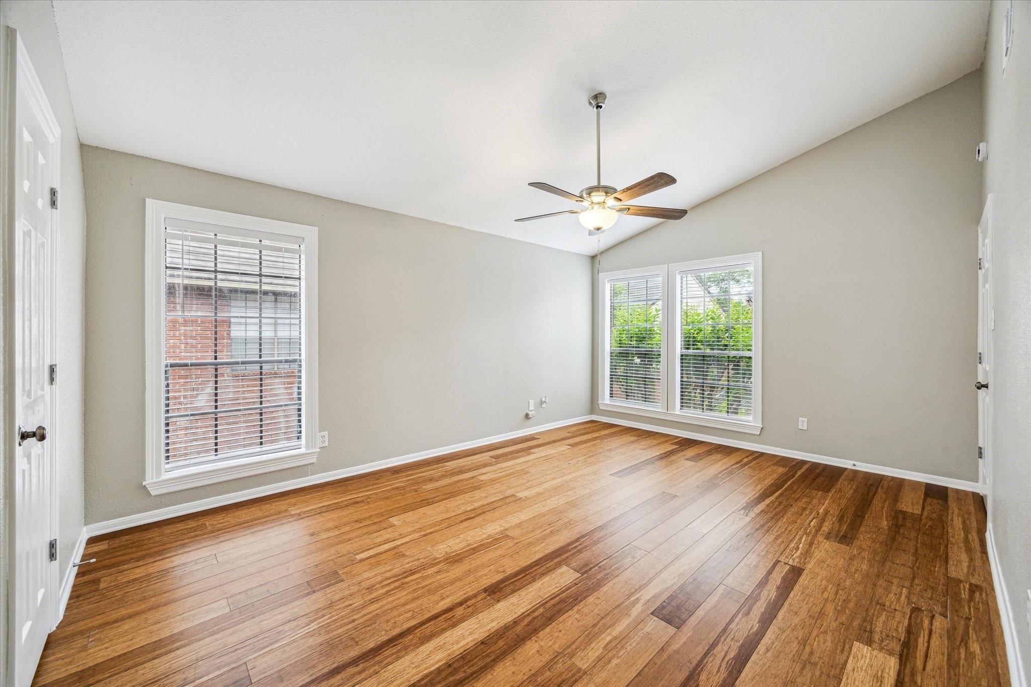 2211 South Kirkwood Road, Unit 9 Houston, TX 77077 - Photo 7 of 16 a view of an empty room with wooden floor and a window