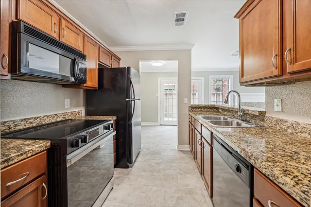 a kitchen with stainless steel appliances granite countertop a stove and a sink