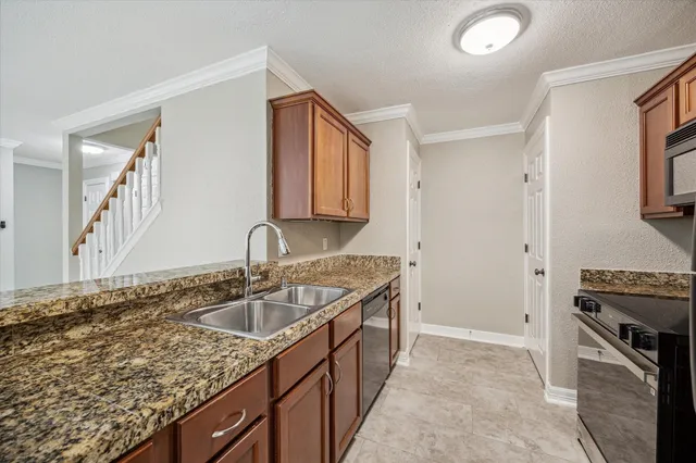 a kitchen that has a sink and a stove