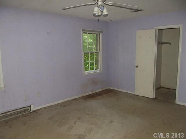 6019 Trotters Ridge Road Charlotte, NC 28227 - Photo 5 of 9 an empty room with windows and fan