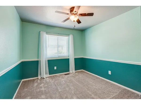 a view of room with window and ceiling fan