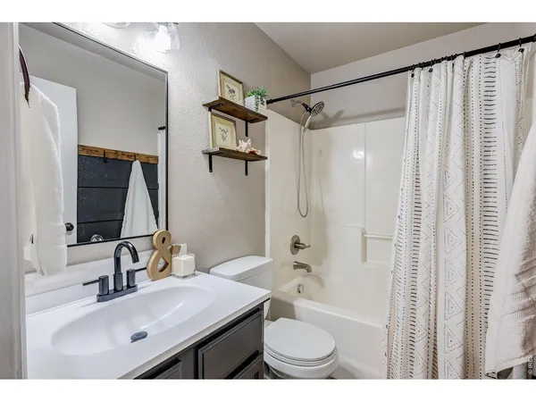 a bathroom with a sink double vanity granite tub shower and a mirror