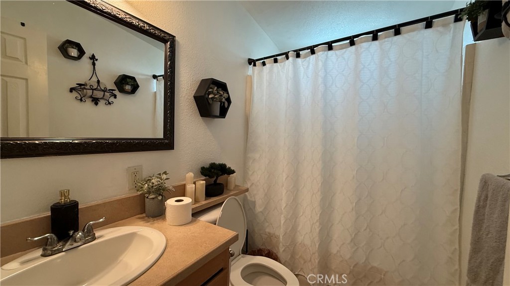 2250 West Mill Street, Unit 70 Colton, CA 92324 - Photo 8 of 14 a bathroom with a sink and mirror