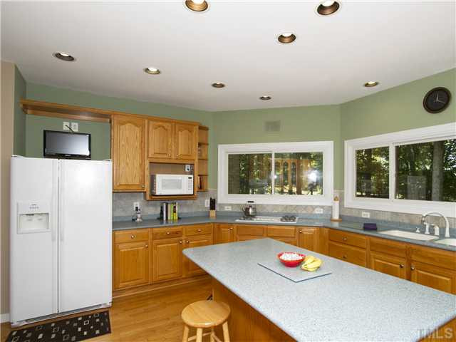 2108 Lovdal Drive Raleigh, NC 27613 - Photo 7 of 25 This view of the kitchen shows the recessed lighting and fantastic countertop and cabinet space. 4 cabinets have glass doors. Kitchen