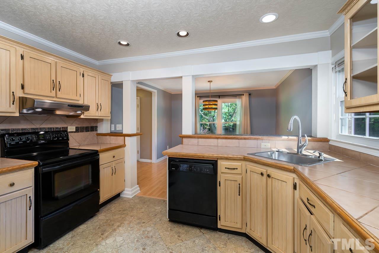 7405 Mine Valley Road Raleigh, NC 27615 - Photo 12 of 24 a kitchen with a sink stove and cabinets