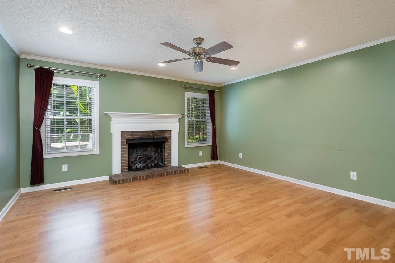 7405 Mine Valley Road Raleigh, NC 27615 - Photo 13 of 24 a view of an empty room with a window and a fireplace