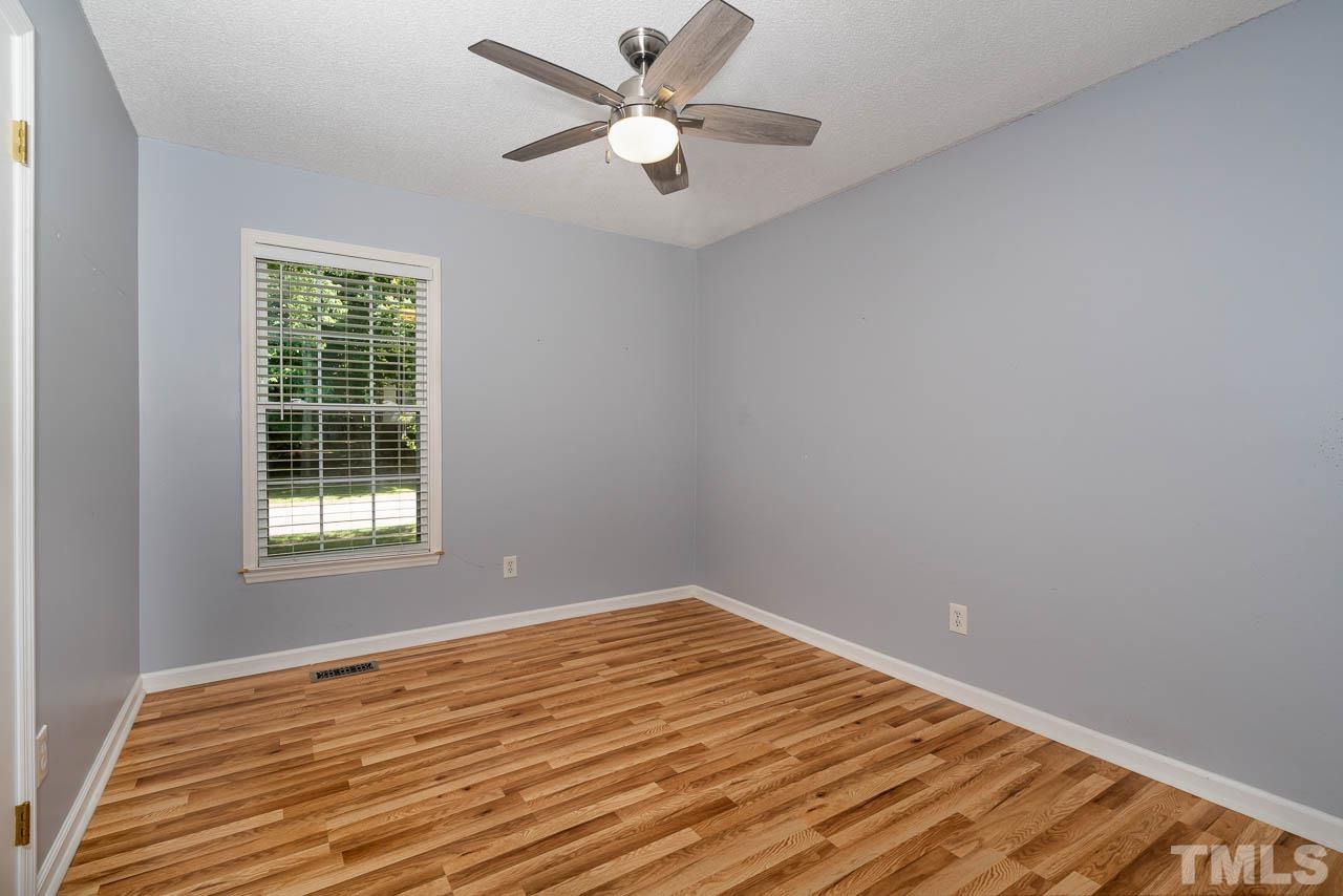 7405 Mine Valley Road Raleigh, NC 27615 - Photo 15 of 24 a view of empty room with wooden floor and fan