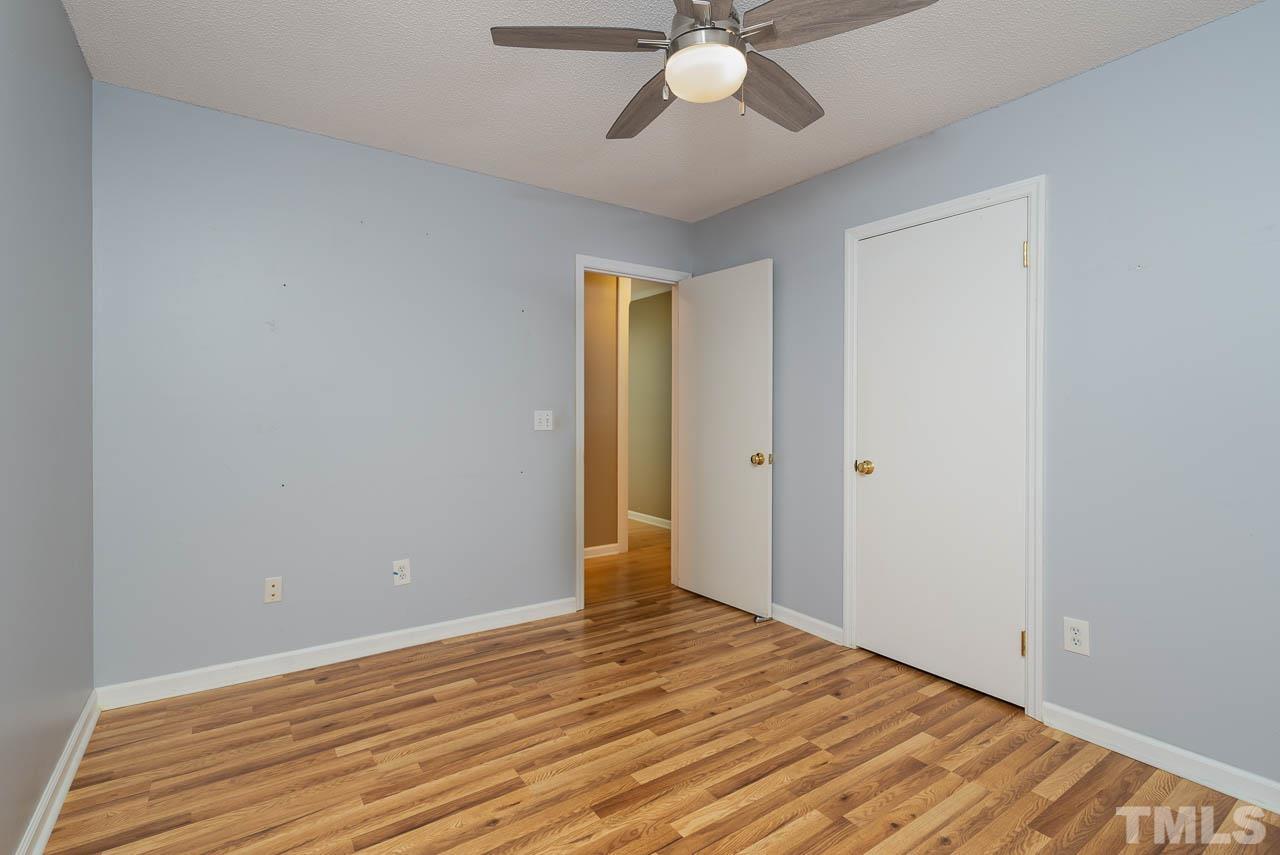 7405 Mine Valley Road Raleigh, NC 27615 - Photo 16 of 24 a view of an empty room with wooden floor