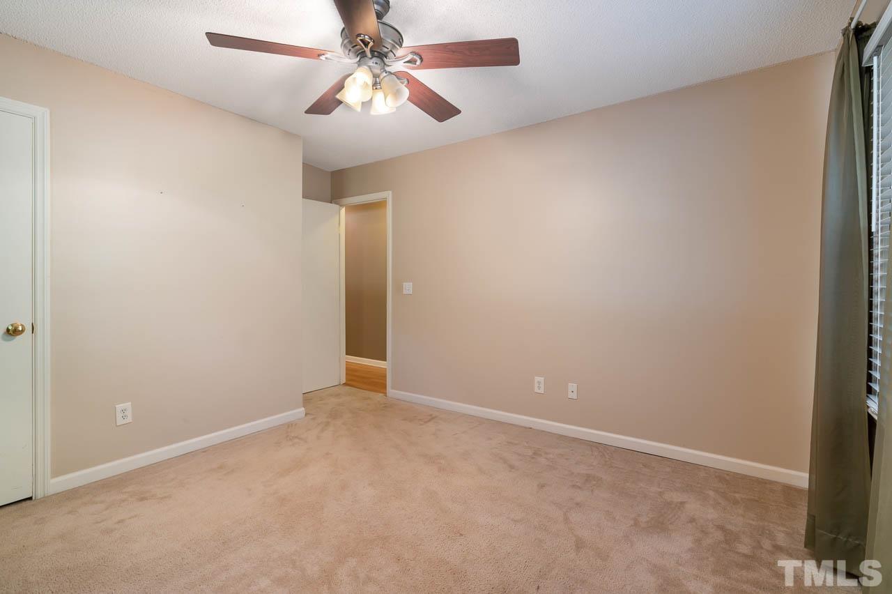 7405 Mine Valley Road Raleigh, NC 27615 - Photo 19 of 24 an empty room with a fan and a fan