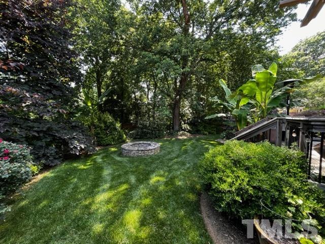 7405 Mine Valley Road Raleigh, NC 27615 - Photo 2 of 24 a backyard of a house with lots of green space and garden