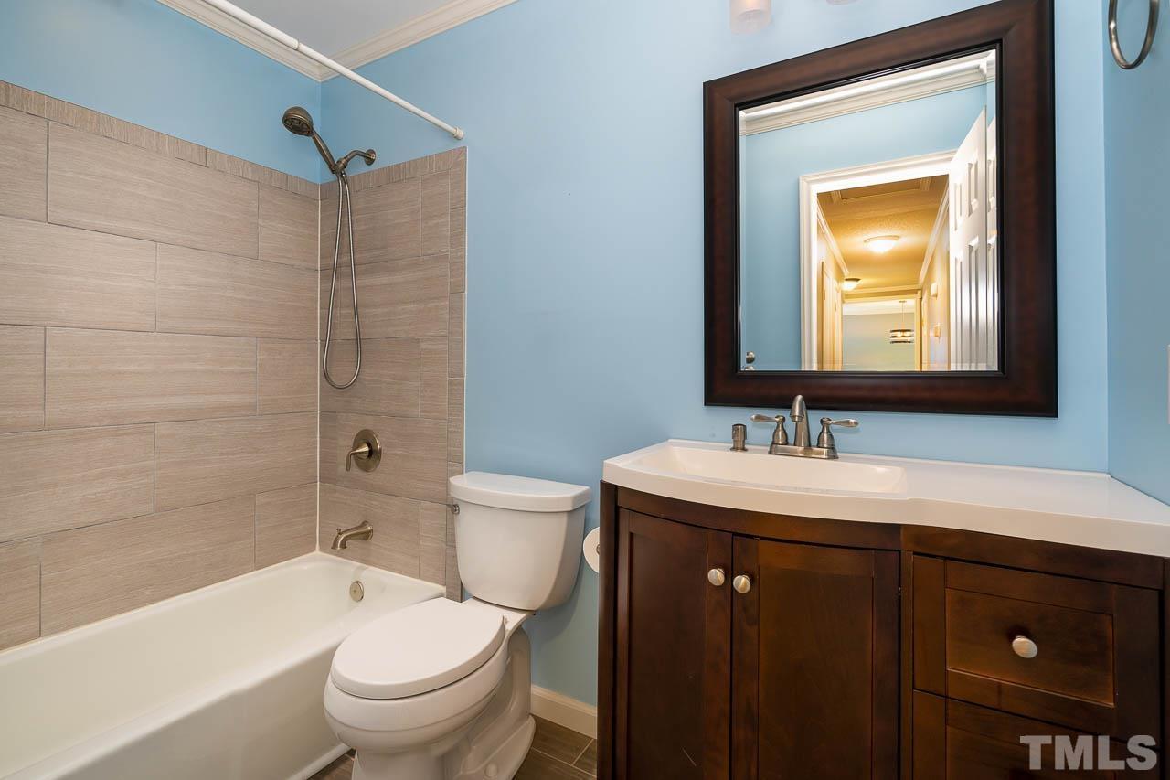 7405 Mine Valley Road Raleigh, NC 27615 - Photo 24 of 24 a bathroom with a sink vanity mirror toilet and bathtub