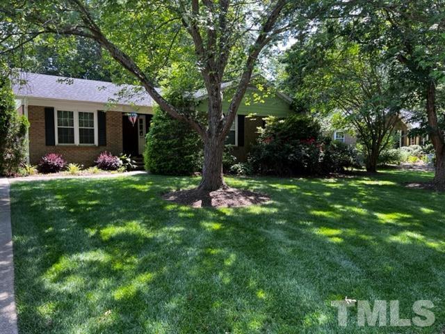7405 Mine Valley Road Raleigh, NC 27615 - Photo 3 of 24 a backyard of a house with table and chairs