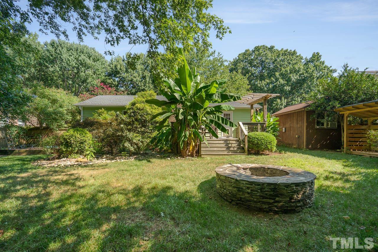 7405 Mine Valley Road Raleigh, NC 27615 - Photo 5 of 24 a view of a backyard with plants and outdoor seating