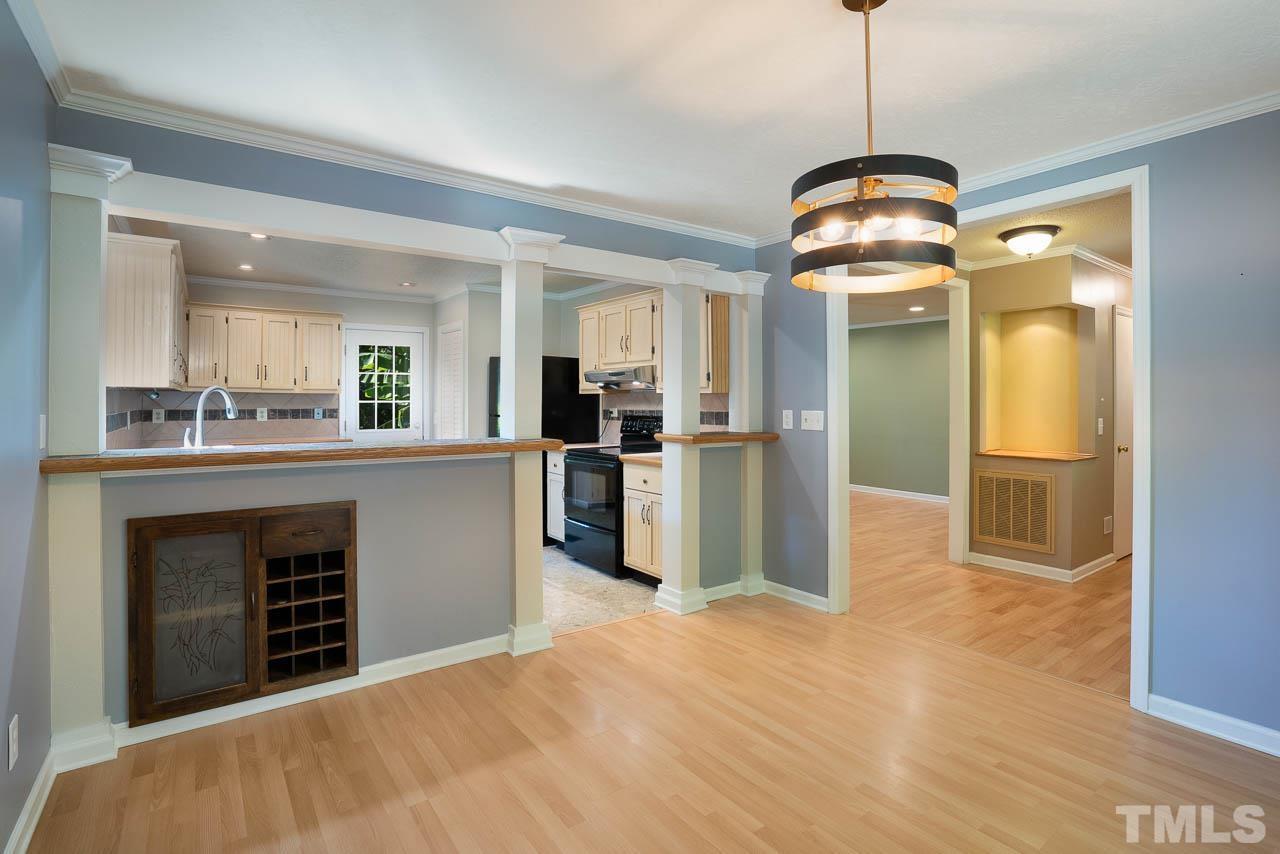 7405 Mine Valley Road Raleigh, NC 27615 - Photo 9 of 24 a view of a kitchen with stainless steel appliances granite countertop cabinets and a wooden floor