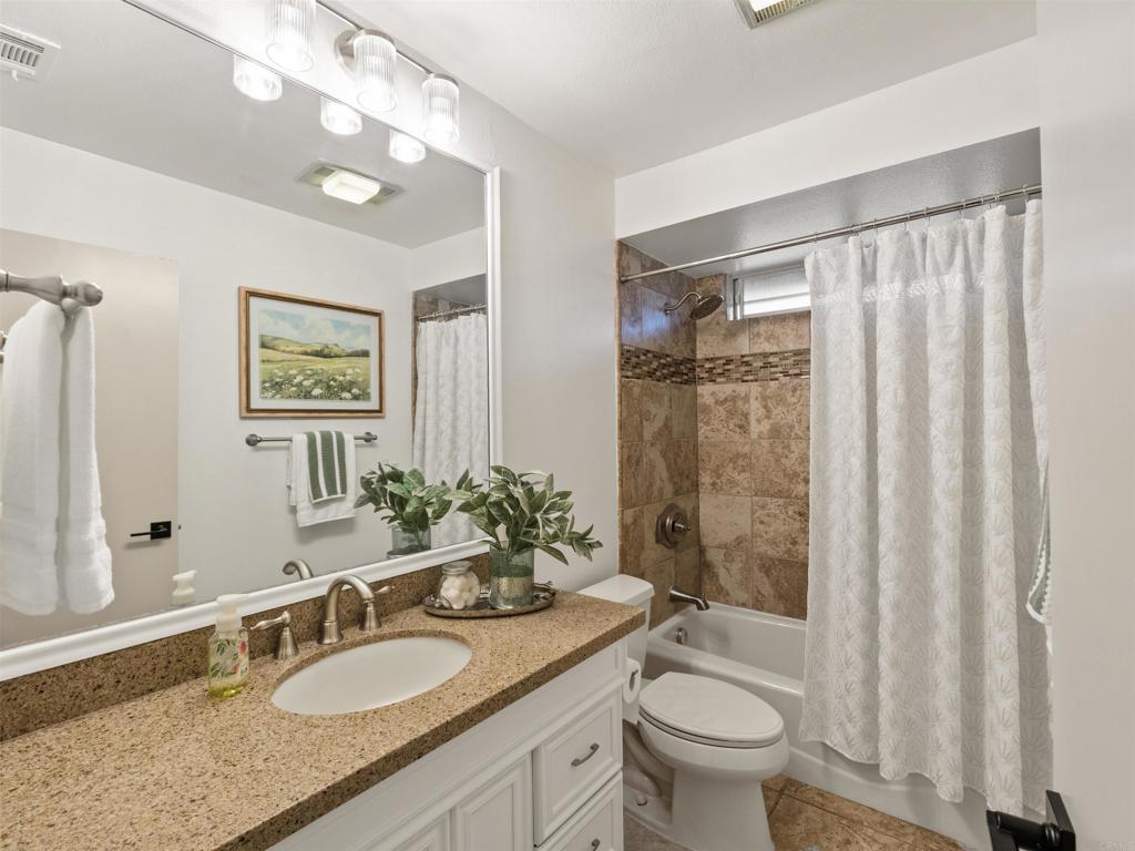 13737 Temple Street Poway, CA 92064 - Photo 25 of 38 a bathroom with a granite countertop double vanity sink toilet and shower