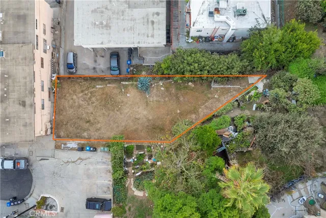 an aerial view of a house with a yard and a fountain