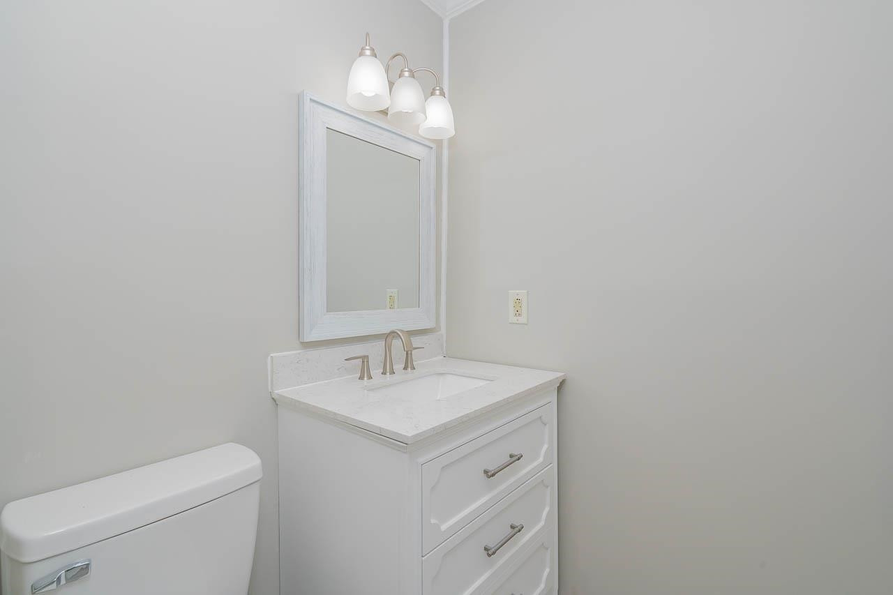 5917 Meadowlark Lane Raleigh, NC 27610 - Photo 12 of 24 a bathroom with a toilet sink and mirror