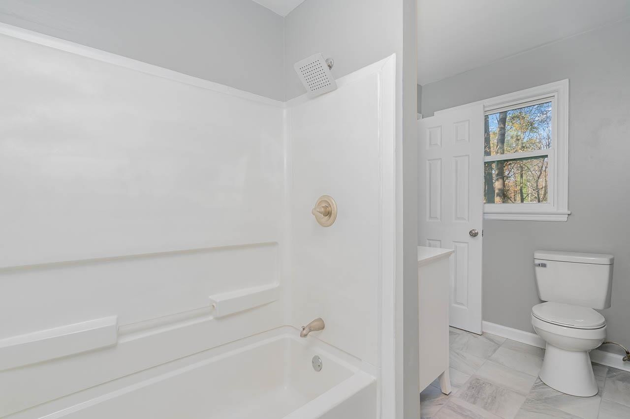 5917 Meadowlark Lane Raleigh, NC 27610 - Photo 13 of 24 a bathroom with a toilet and a bathtub
