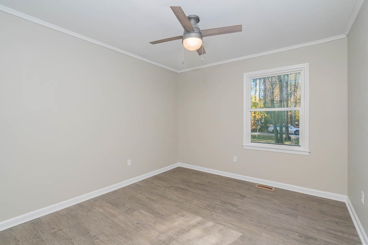 5917 Meadowlark Lane Raleigh, NC 27610 - Photo 18 of 24 an empty room with a window and a ceiling fan