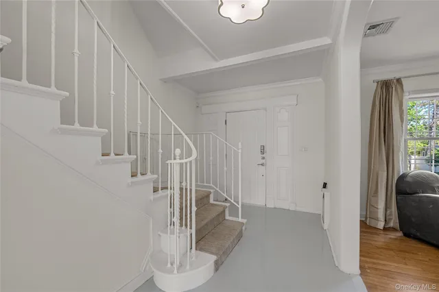a view of entryway and hall with wooden floor