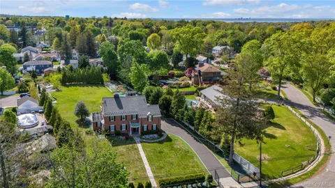 an aerial view of a house with swimming pool garden and mountain view