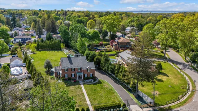 an aerial view of a house with swimming pool garden and mountain view
