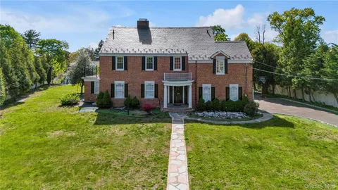 a front view of a house with a yard table and chairs