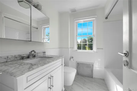 a view of a house with a big yard and potted plants
