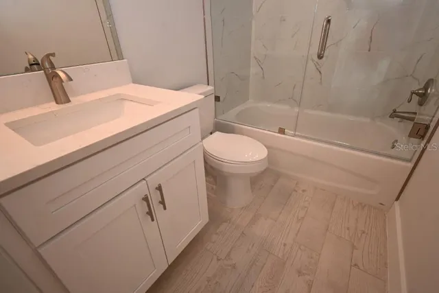 a bathroom with a sink a toilet and bathtub