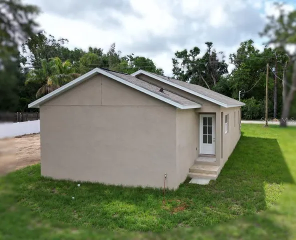a aerial view of a house next to a yard